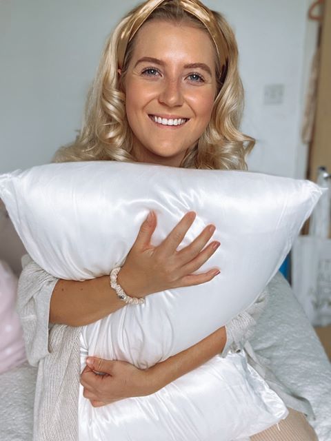Donna felice con federa in seta bianca Bella Seta, delicata su pelle e capelli